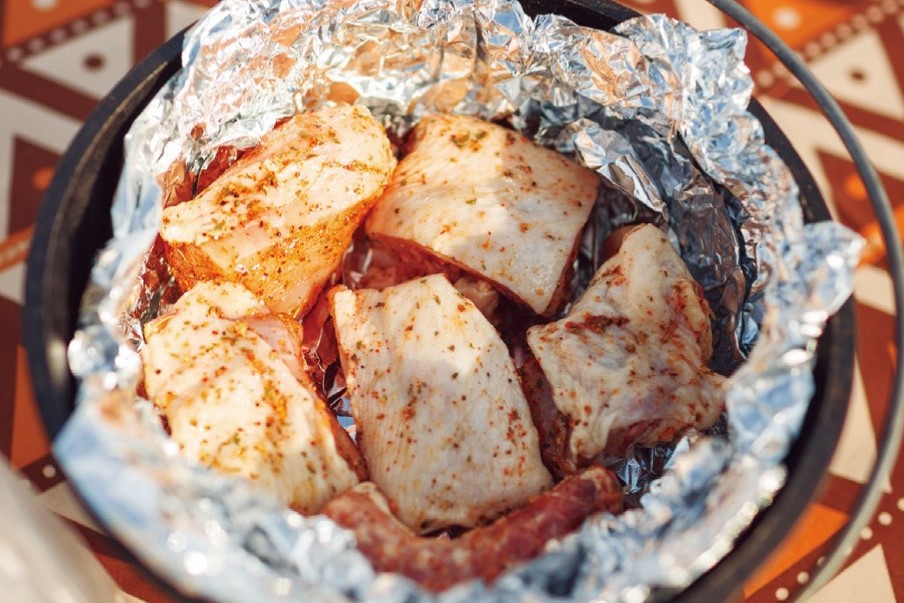 先將鋁箔紙放到鑄鐵鍋中，再放入雞肉塊，不要讓肉直接碰到鍋子。